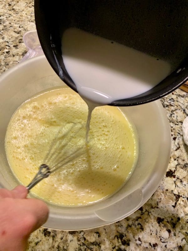 adding milk to sugar