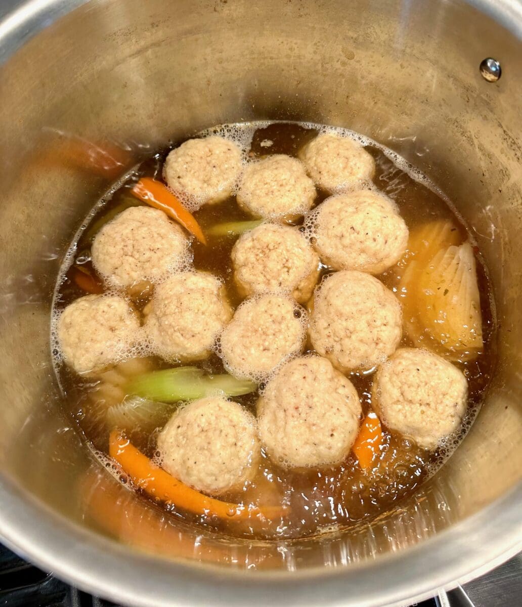 cooking the matzo balls in chili broth